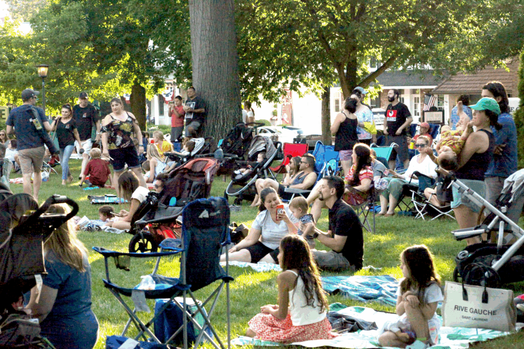 People sitting on front lawn for an event